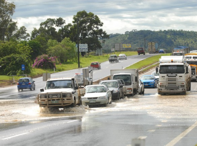 Vehicles negotiate floodwaters at the Laidley turnoff on the Warrego Highway. Photo David Martinelli